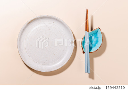 Minimal Sushi Plate with Chopsticks on Beige Background 139442210