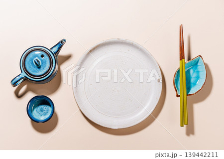 Asian Table Setting with Plate Teapot and Chopsticks Asian Table Setting with Plate Teapot and Chopsticks 139442211