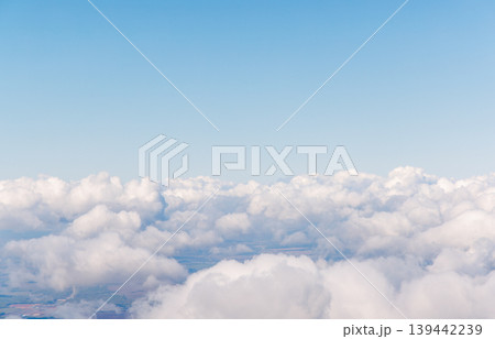 Sunlit sky above clouds from airplane 139442239