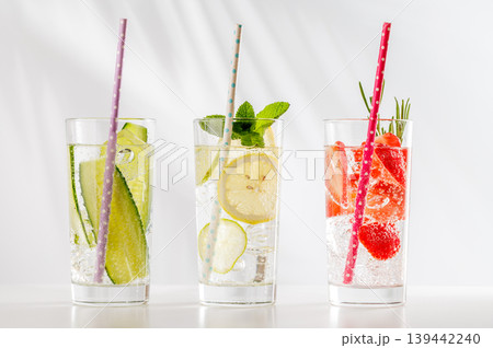 Set of fresh non alcoholic drinks with strawberry cucumber and lemon on white background Set of fresh non alcoholic drinks with strawberry cucumber and lemon on white background 139442240