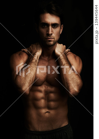 Six pack, black background or portrait of man for workout, training or exercise in studio for fitness. Model, dark shadow or ripped male person with healthy body, abs or stomach for wellness in Italy Six pack, black background or portrait of man for workout, training or exercise in studio for fitness. Model, dark shadow or ripped male person with healthy body, abs or stomach for wellness in Italy 139445644