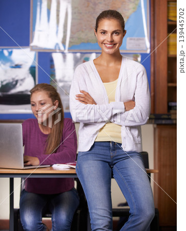 Woman, teacher portrait and student in classroom on laptop for education, learning and teaching in geography at high school. Happy mentor or class educator with arms crossed or leadership for support Woman, teacher portrait and student in classroom on laptop for education, learning and teaching in geography at high school. Happy mentor or class educator with arms crossed or leadership for support 139445702