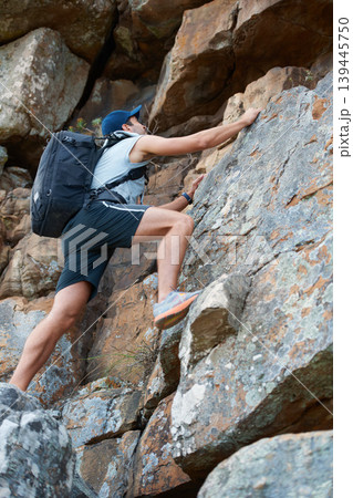 Man, mountain or rock climbing in nature for extreme sports, fitness or exercise training. Fearless athlete, person or hiking cliff stone for risk challenge, adventure or wellness in summer workout 139445750