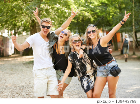 Celebration, hug and friends at a park for festival, concert or happy social gathering. Face, fun and people in a forest with freedom, energy and excited for event, reunion or party with rocker hands 139445769