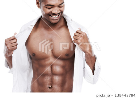 Man, fashion and muscle with abs, shirt and dressing for chest, african and male model in white background. Alone, smile and happy with six pack, body and corporate wear, stylish and masculine Man, fashion and muscle with abs, shirt and dressing for chest, african and male model in white background. Alone, smile and happy with six pack, body and corporate wear, stylish and masculine 139445794