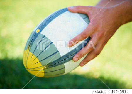 Sports, rugby and ball in hands of person on field for training, competition and practice. Fitness, game and performance with closeup of athlete in outdoor pitch for challenge, score and health 139445919