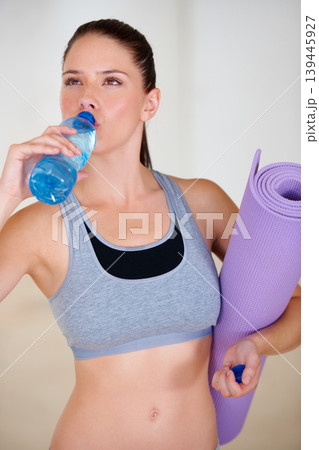 Health, fitness and young woman drinking water for pilates workout or exercise in gym. Nutrition, sports and thirsty female athlete enjoying hydration beverage for training at wellness class Health, fitness and young woman drinking water for pilates workout or exercise in gym. Nutrition, sports and thirsty female athlete enjoying hydration beverage for training at wellness class 139445927