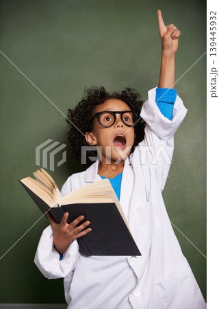 Child, hand for answer and book in classroom, education and science learning or physics knowledge by chalkboard. African student wow with glasses and solution or problem solving in textbook at school Child, hand for answer and book in classroom, education and science learning or physics knowledge by chalkboard. African student wow with glasses and solution or problem solving in textbook at school 139445932