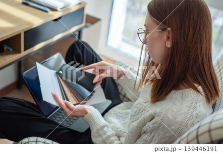 Woman choosing color swatches for home interior design project 139446191