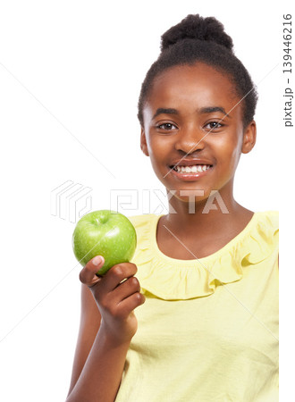 Portrait, girl and kid with nutrition, apple and smile isolated on a white studio background. Face, African person and model with organic fruit, healthy snack and wellness with diet, happy and joy 139446216