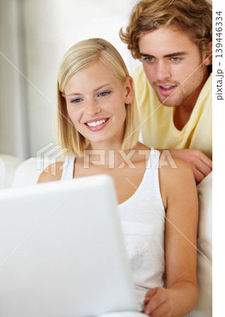 Happy, laptop and young couple on sofa browsing on social media or the internet at apartment. Smile, technology and man and woman relax and researching on website with computer in living room at home 139446334