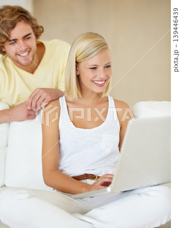 Smile, laptop and young couple on sofa browsing on social media or the internet at apartment. Relax, technology and happy man and woman doing research on website with computer in living room at home. 139446439