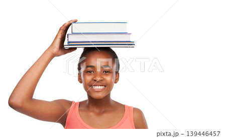 Portrait, smile and black girl with books on her head, education and balance isolated on a white studio background. Face, African person and model with mockup space and learning with knowledge 139446457