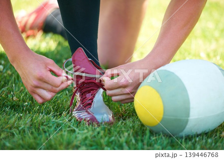 Rugby, ball and sports with shoes of person on field for training, practice and challenge. Health, start and games with closeup of athlete tying laces on outdoor pitch for stadium and fitness Rugby, ball and sports with shoes of person on field for training, practice and challenge. Health, start and games with closeup of athlete tying laces on outdoor pitch for stadium and fitness 139446768