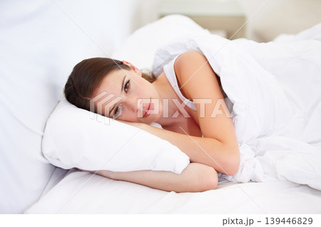 Portrait, home and bedroom with woman, resting and relax with weekend break, lazy and healthy. Face, person and apartment with girl, pillow and peace with freedom, cushion and blanket with wellness 139446829
