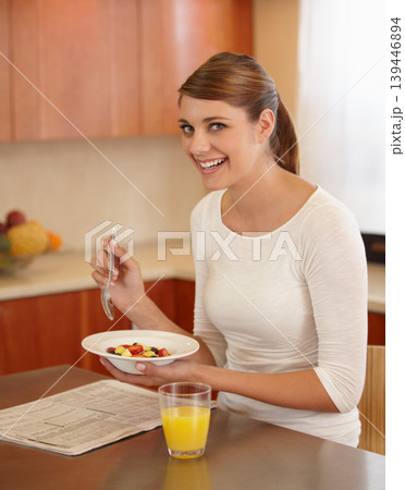 Breakfast, fruit salad and portrait of woman in kitchen for healthy eating, nutrition and detox diet. Happy, morning and person with orange juice, food and bowl for wellness, organic or natural snack 139446894