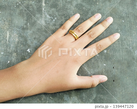 Close up of gold wedding ring. Ring gold wedding on finger hand Close up of gold wedding ring. Ring gold wedding on finger hand 139447120