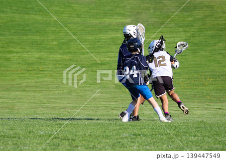 Young boys playing Lacrosse game Young boys playing Lacrosse game 139447549