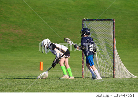 Young boys playing Lacrosse game 139447551
