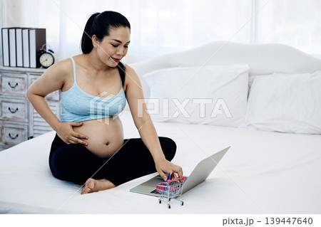 Pregnant woman using laptop for online shopping at home, modern motherhood and ecommerce lifestyle concept with digital payment, prenatal preparation and family financial management Pregnant woman using laptop for online shopping at home, modern motherhood and ecommerce lifestyle concept with digital payment, prenatal preparation and family financial management 139447640