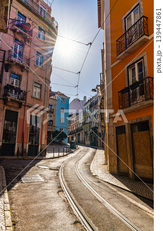 lisbon street with tram tracks and colorful buildings in sunlight portugal lisbon street with tram tracks and colorful buildings in sunlight portugal 139447861