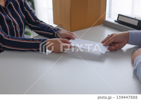 Manager Terminating Employee and Handing Over Severance Document. 139447888