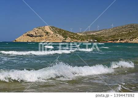 Golden sandy beach on Rhodes, Greece, with gentle waves and blue horizon, ideal holiday destination. Golden sandy beach on Rhodes, Greece, with gentle waves and blue horizon, ideal holiday destination. 139447892