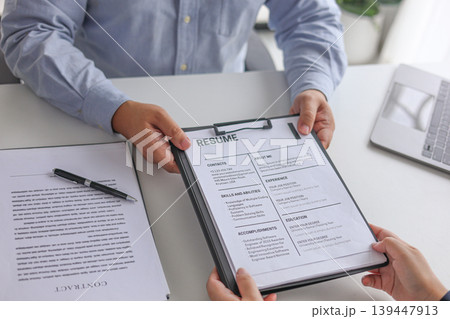 Business People Reviewing Resume During Job Interview Meeting. Business People Reviewing Resume During Job Interview Meeting. 139447913
