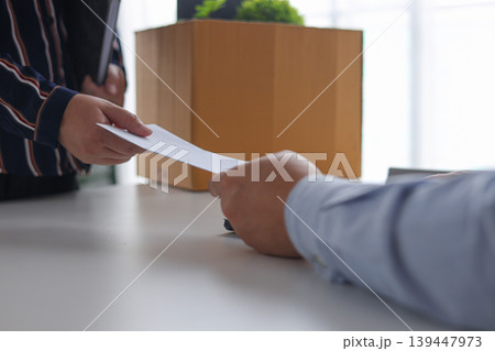 A Manager Providing a Termination Notice or a Separation Packet to a Staff Member. A Manager Providing a Termination Notice or a Separation Packet to a Staff Member. 139447973