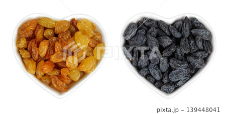 Yellow and black Raisins in ceramic bowl isolated on white background. Top view. Flat lay Yellow and black Raisins in ceramic bowl isolated on white background. Top view. Flat lay 139448041
