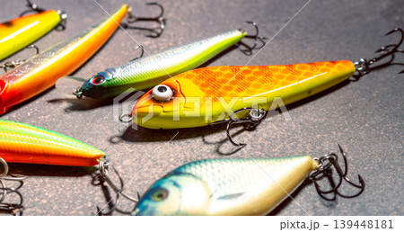 Fishing baits tackles lures on wooden background. Accessories for fishing Fishing baits tackles lures on wooden background. Accessories for fishing 139448181
