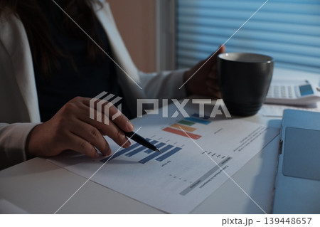 Businesswoman working over time in the dark office room late at night. Businesswoman working over time in the dark office room late at night. 139448657