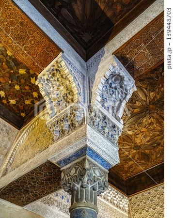 Intricate Islamic Architecture Interior With Ornate Carved Column, Muqarnas Arches and Wooden Ceiling, Alhambra, Granada Intricate Islamic Architecture Interior With Ornate Carved Column, Muqarnas Arches and Wooden Ceiling, Alhambra, Granada 139448703