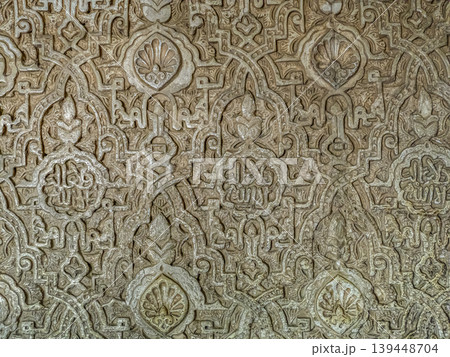 Carved Islamic Plaster Wall With Ornate Arabic Geometric Patterns And Intricate Arabesque Ornamentation, Alhambra, Granada Carved Islamic Plaster Wall With Ornate Arabic Geometric Patterns And Intricate Arabesque Ornamentation, Alhambra, Granada 139448704