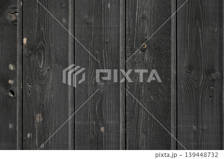 Weathered vertical wood texture featuring dark, aged wooden tones, suitable for architectural or design projects. Weathered vertical wood texture featuring dark, aged wooden tones, suitable for architectural or design projects. 139448732