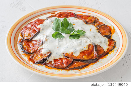 Burani Bonjan Afghan eggplant dish with yogurt garlic sauce and parsley garnish Burani Bonjan Afghan eggplant dish with yogurt garlic sauce and parsley garnish 139449040