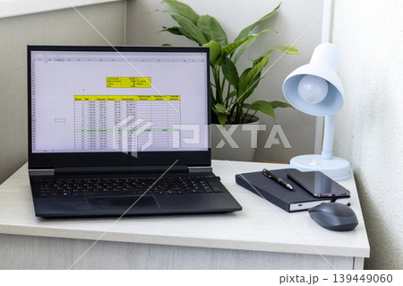 Laptop screen on the modern desk showing spreadsheet with loan amortization table 139449060