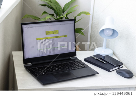 Laptop screen on the modern desk showing spreadsheet with loan amortization table 139449061