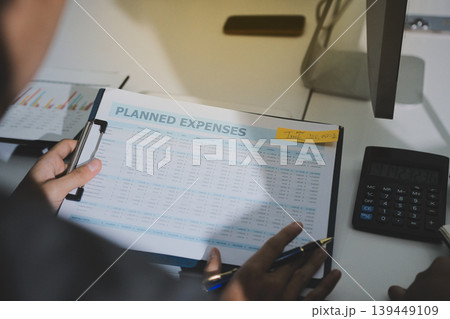 Accounting company provide finance and taxation planning for profitable cash flow, Auditor accountant working in office, analyze financial data and accounting record with calculator Accounting company provide finance and taxation planning for profitable cash flow, Auditor accountant working in office, analyze financial data and accounting record with calculator 139449109