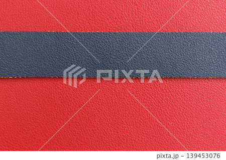 shiny red leather background with dark blue strap 139453076