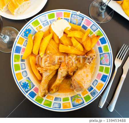 Chicken thigh served with potatoes on dinner plate Chicken thigh served with potatoes on dinner plate 139453488