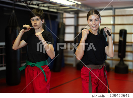 Teenagers holding nunchucks in their hands Teenagers holding nunchucks in their hands 139453641
