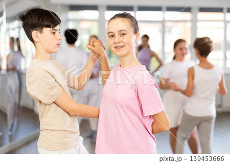 Group of teenagers, girls and boys, dance a slow ballroom dance in choreography studio 139453666