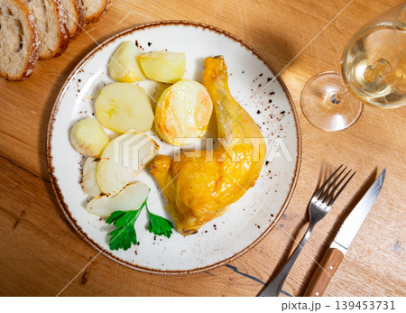 Braised chicken thigh with potatoes on a ceramic plate cooked in cafe Braised chicken thigh with potatoes on a ceramic plate cooked in cafe 139453731