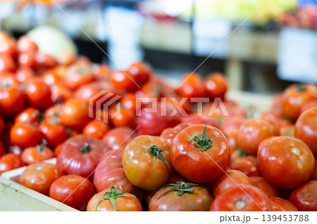 Fresh red tomatoes displayed on store counter for sale Fresh red tomatoes displayed on store counter for sale 139453788