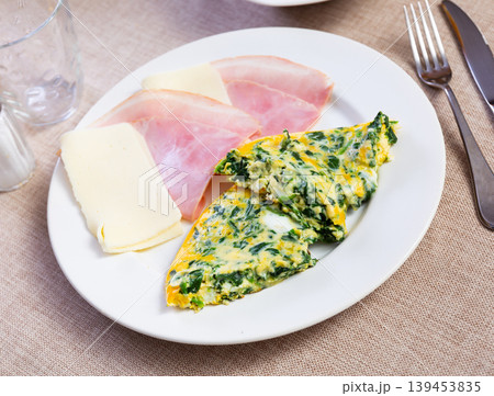 Two slices of omelet, bacon and cheese 139453835