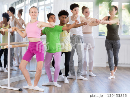 Teenage girl practicing plie position of ballet during choreography classes 139453836