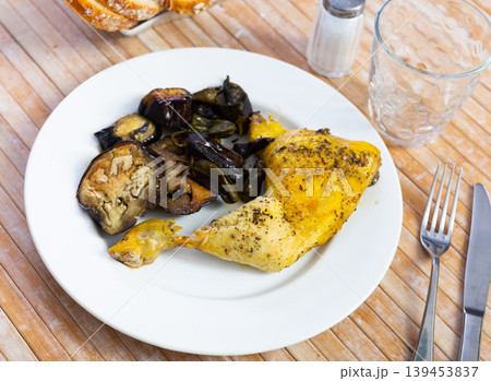 Chicken thigh with stewed eggplant on a ceramic plate cooked in cafe 139453837