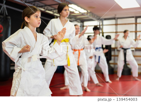 Group of children and teenagers practice karate 139454003