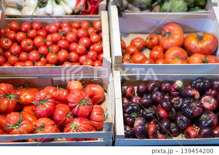 Fresh red tomatoes displayed on store counter for sale Fresh red tomatoes displayed on store counter for sale 139454200